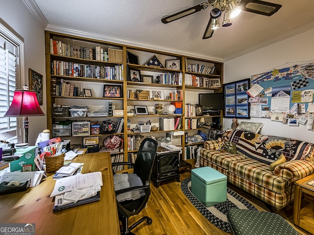 home office with hardwood / wood-style flooring, ceiling fan, crown molding, and a textured ceiling