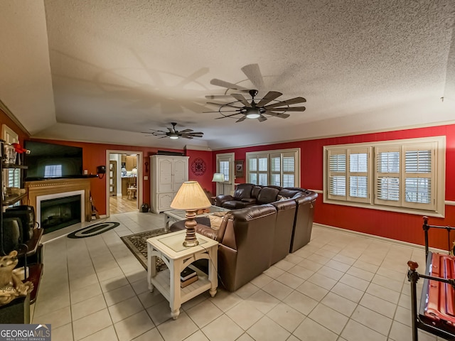 tiled living room with a textured ceiling and ceiling fan