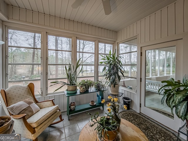 sunroom featuring vaulted ceiling, ceiling fan, and wood ceiling