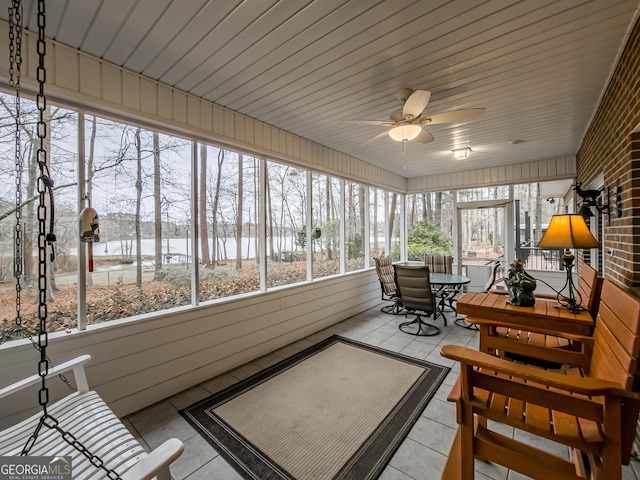 sunroom with a healthy amount of sunlight and ceiling fan