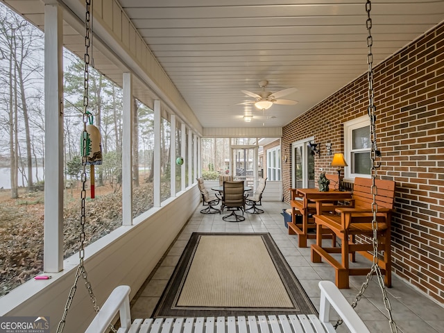 sunroom featuring plenty of natural light and ceiling fan