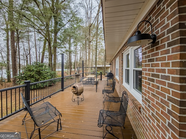 wooden deck featuring area for grilling