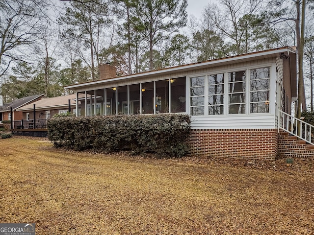 rear view of house with a sunroom