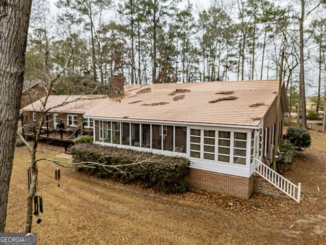 back of house with a sunroom