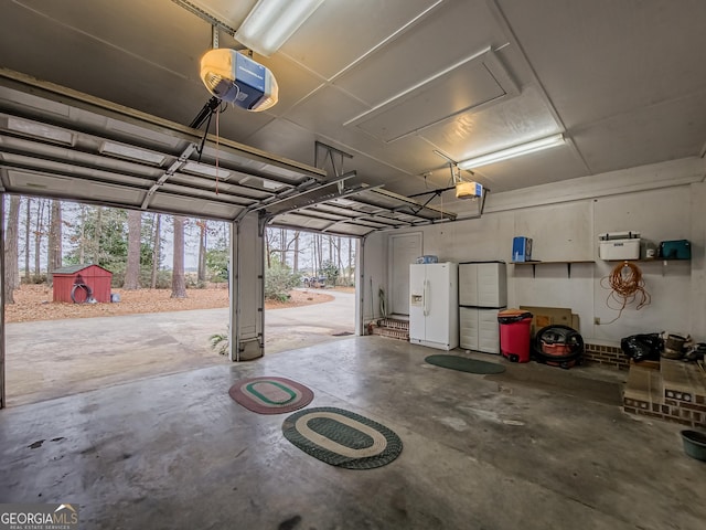 garage with white refrigerator with ice dispenser and a garage door opener