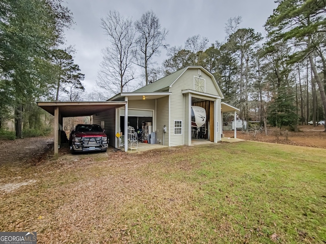 view of outdoor structure featuring a garage and a lawn