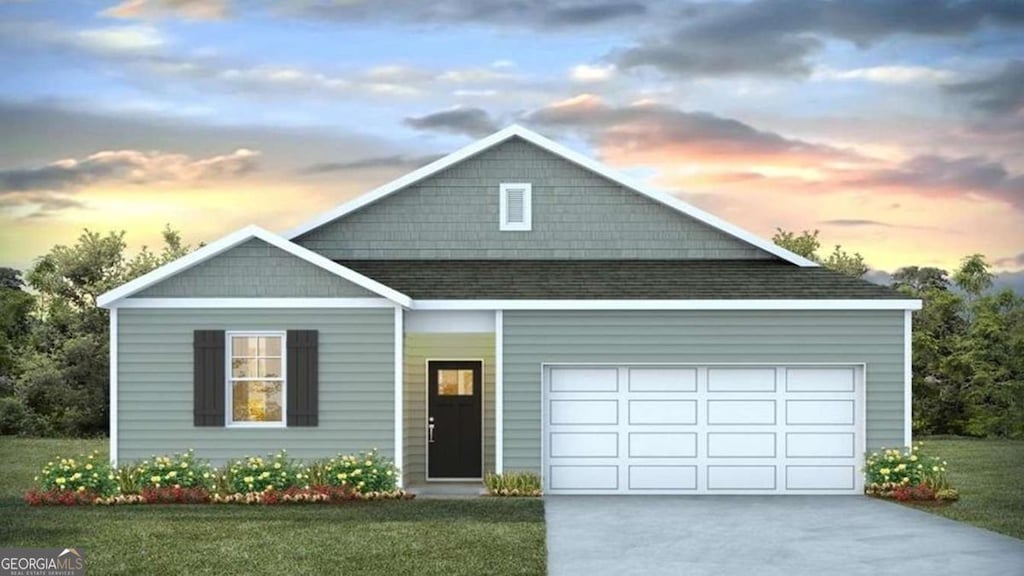 view of front facade with a garage and a lawn