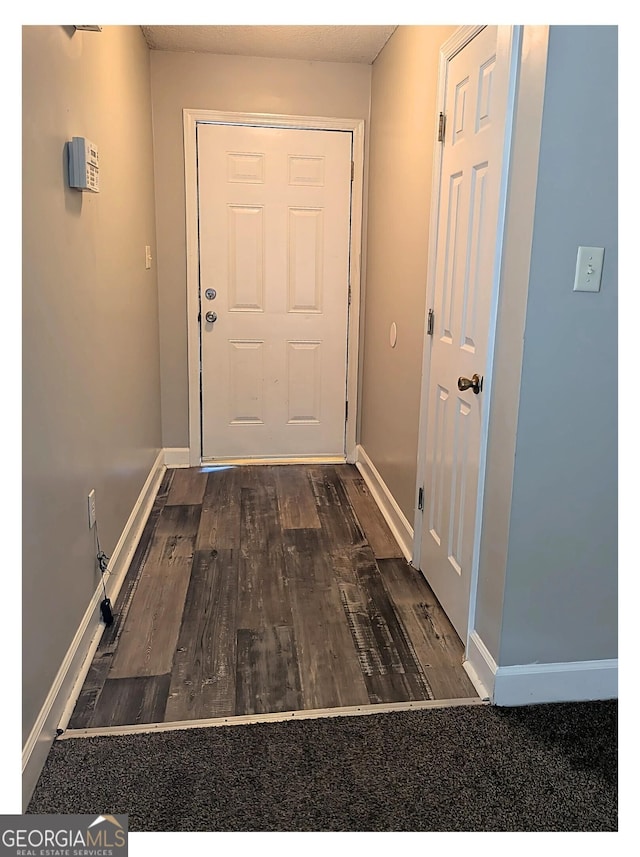 doorway to outside with dark hardwood / wood-style flooring