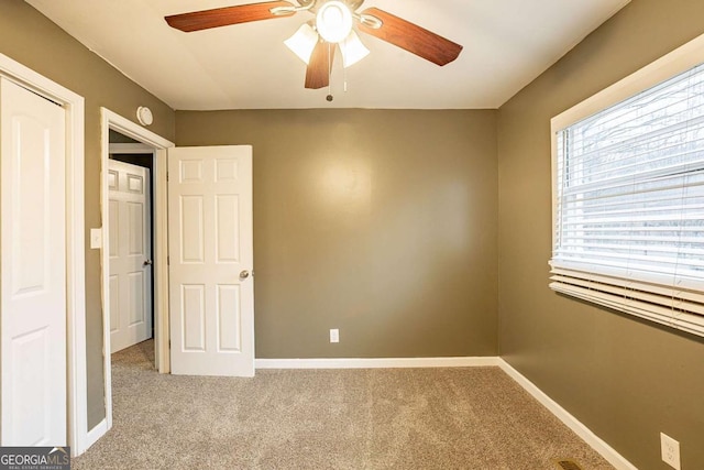 unfurnished bedroom featuring light carpet and ceiling fan