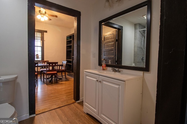 interior space featuring vanity, hardwood / wood-style floors, and toilet