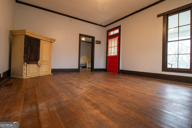 unfurnished living room with ornamental molding and dark wood-type flooring