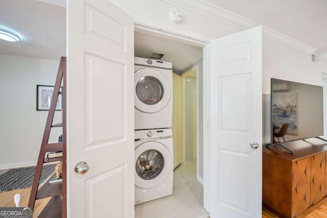 clothes washing area with stacked washer / drying machine