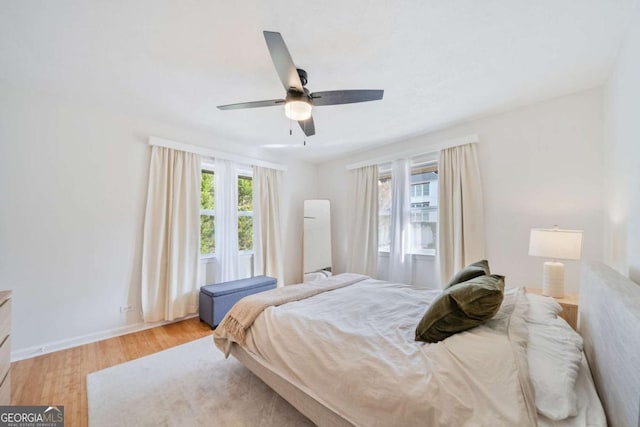 bedroom with ceiling fan and light hardwood / wood-style floors