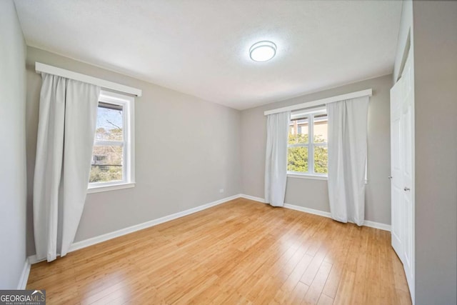 spare room with light wood-type flooring