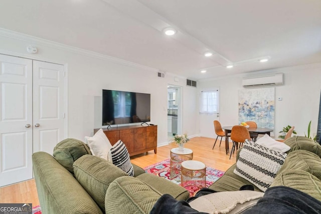 living room with crown molding, a wall mounted air conditioner, and light hardwood / wood-style floors