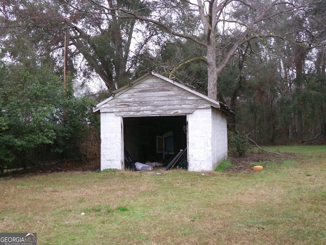 view of outbuilding featuring a lawn