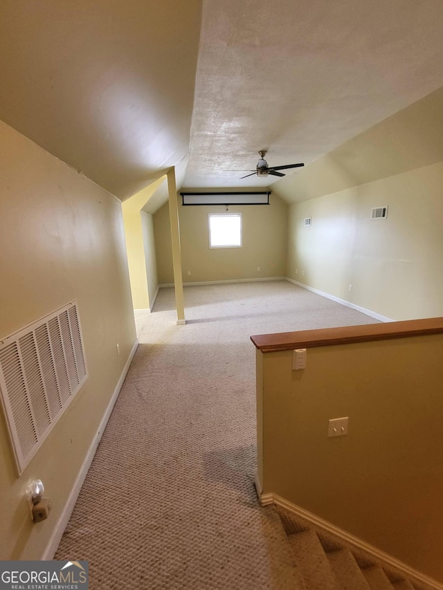 bonus room featuring ceiling fan, lofted ceiling, and carpet