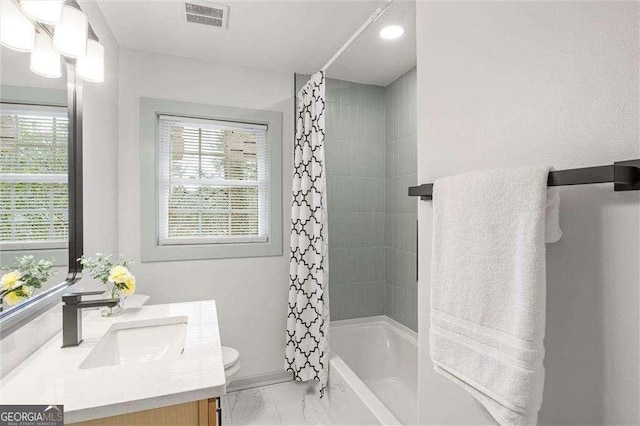 full bathroom with shower / tub combo, vanity, plenty of natural light, and toilet