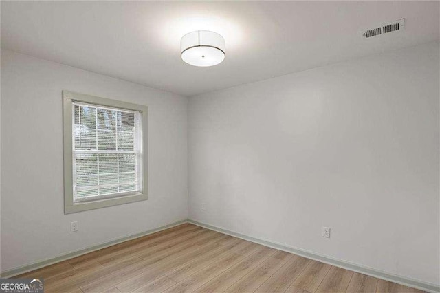 empty room with light hardwood / wood-style flooring