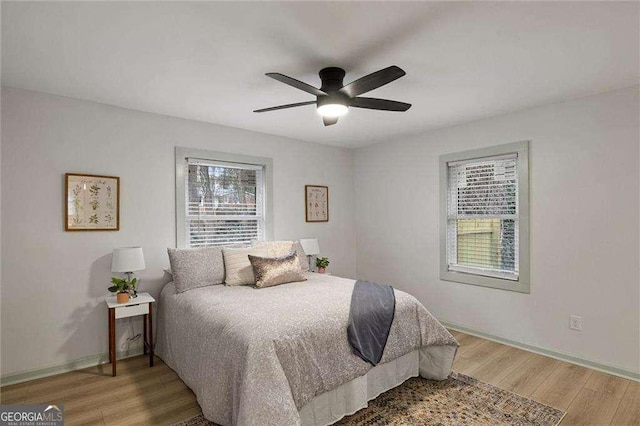 bedroom with hardwood / wood-style flooring and ceiling fan