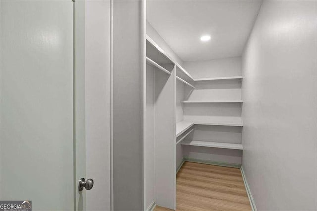 spacious closet with light hardwood / wood-style floors