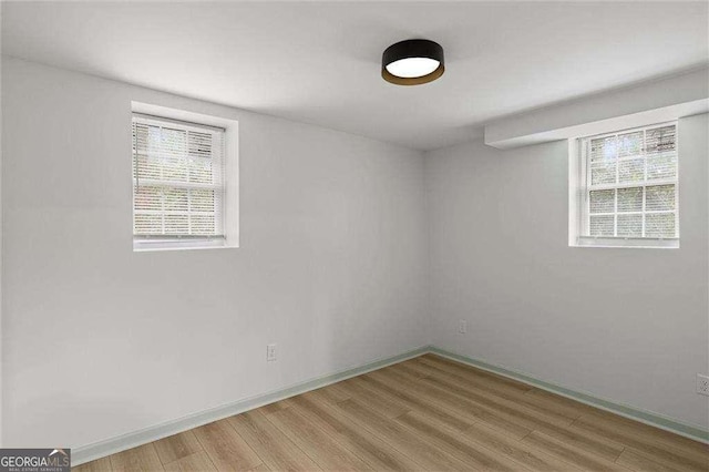 unfurnished room with hardwood / wood-style flooring