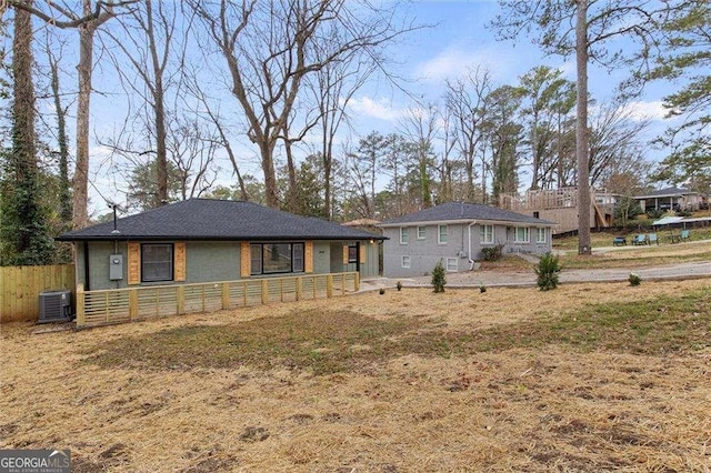 view of front facade featuring central AC unit and a front yard