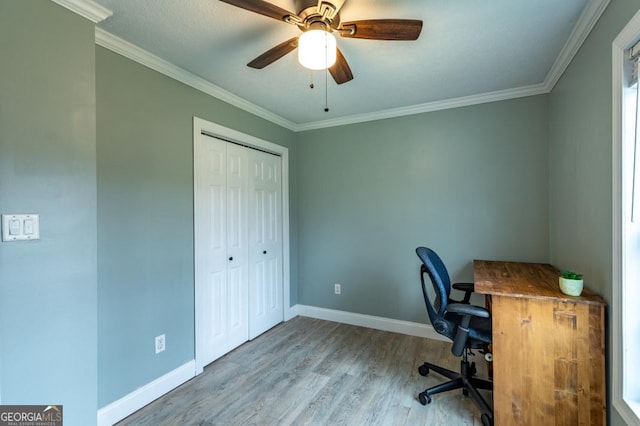 home office featuring crown molding, ceiling fan, and light wood-type flooring