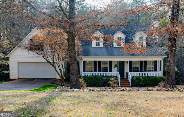 cape cod house with a porch, a garage, and a front yard