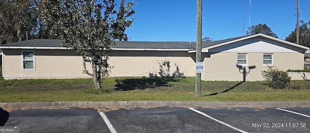 view of property exterior with a lawn