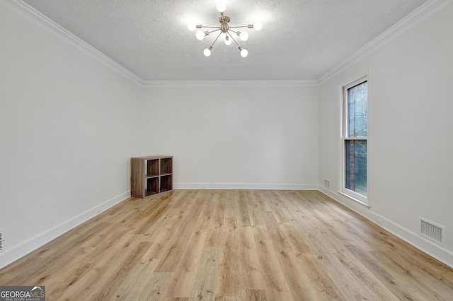 unfurnished room featuring ornamental molding, a chandelier, a textured ceiling, and light hardwood / wood-style flooring