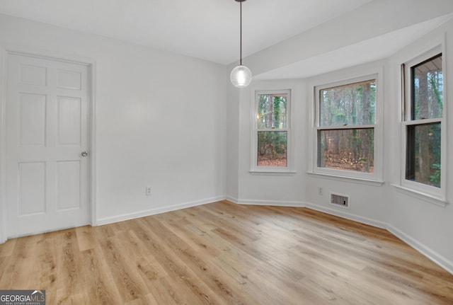 spare room featuring light hardwood / wood-style flooring