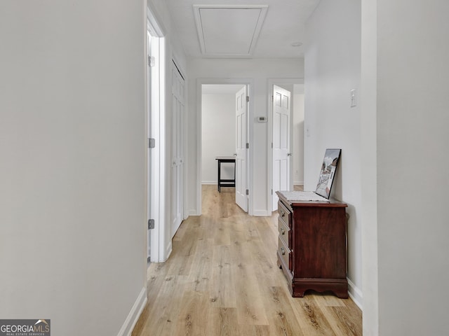 corridor with light wood-type flooring