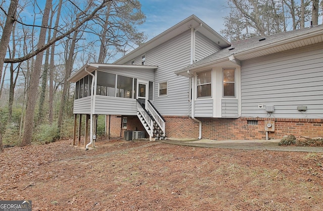 back of house featuring a sunroom