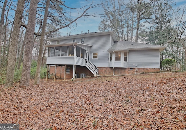 rear view of property with a sunroom