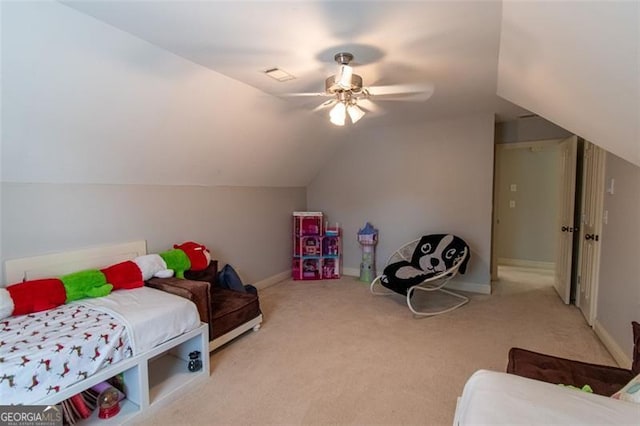 carpeted bedroom with ceiling fan and vaulted ceiling