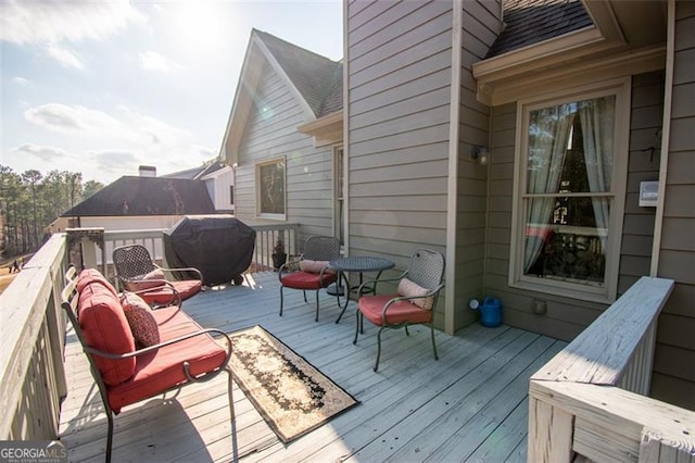 wooden deck featuring a grill