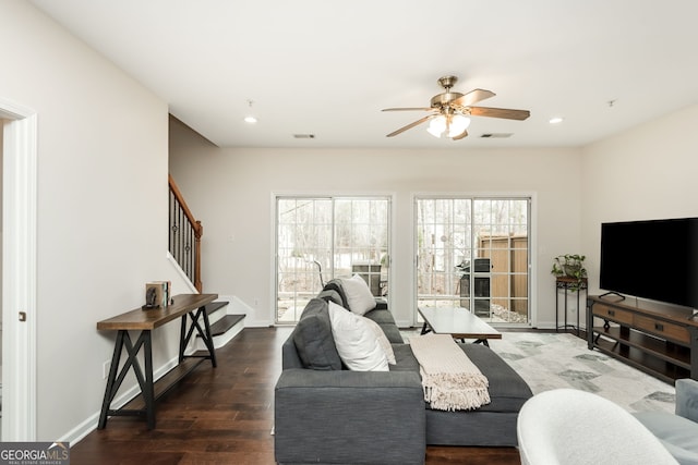 living room with dark hardwood / wood-style flooring and ceiling fan