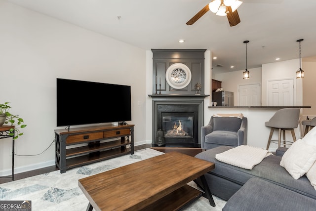 living room with ceiling fan and light hardwood / wood-style floors