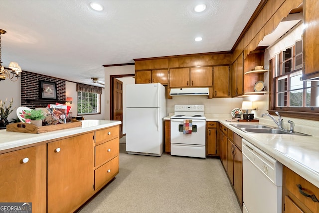 kitchen featuring sink, a textured ceiling, pendant lighting, white appliances, and ceiling fan with notable chandelier