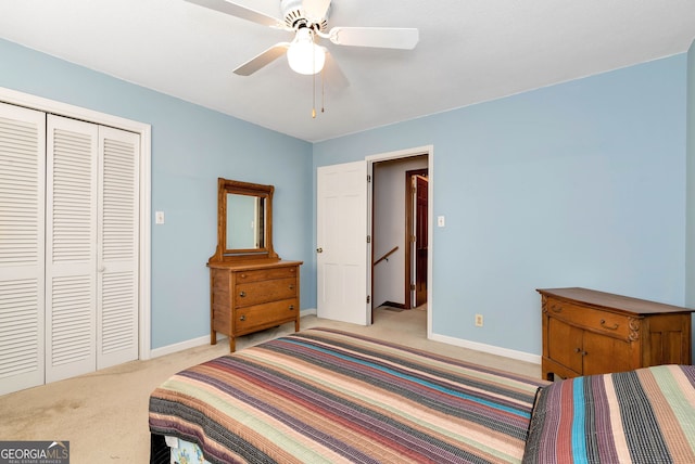 carpeted bedroom featuring a closet and ceiling fan