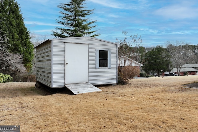 view of outbuilding featuring a yard