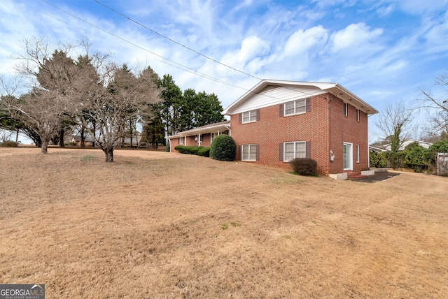 view of side of home featuring a yard