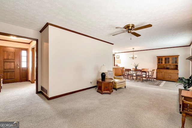 living area featuring light carpet, crown molding, ceiling fan with notable chandelier, and a textured ceiling