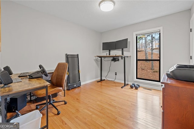 home office with hardwood / wood-style floors