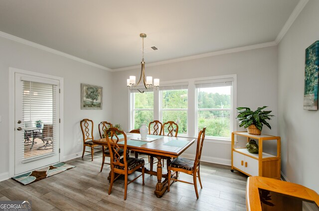 dining room featuring hardwood / wood-style flooring and crown molding