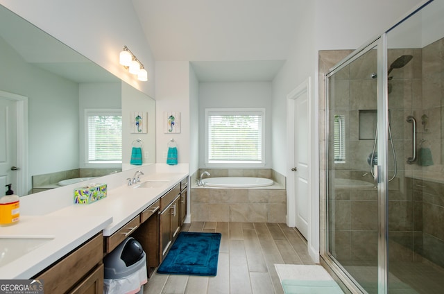 bathroom featuring vanity, shower with separate bathtub, and a wealth of natural light