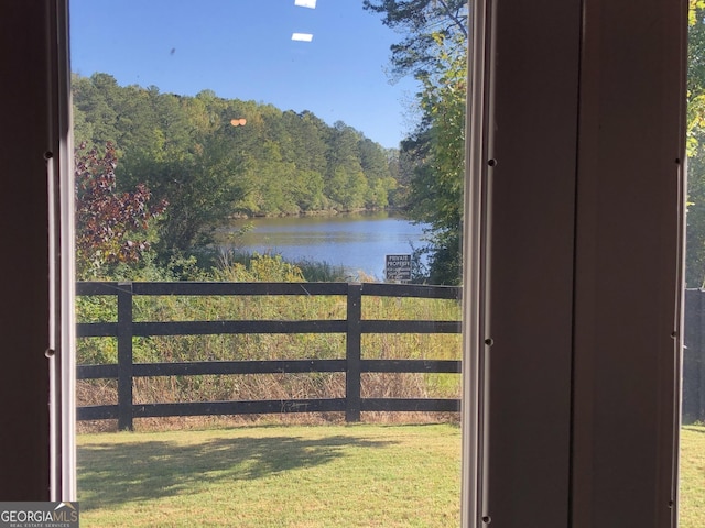 view of gate featuring a yard and a water view