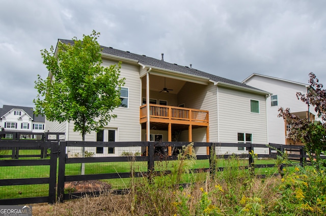 rear view of property with ceiling fan and a balcony