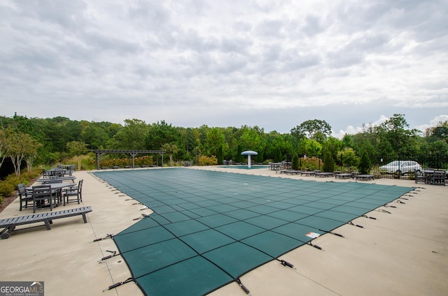 view of pool with a pergola and a patio